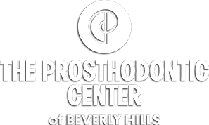 The image shows a logo for the Prosthodontic Center of Beverly Hills, which is part of the Prosthodontic Modesto Center.